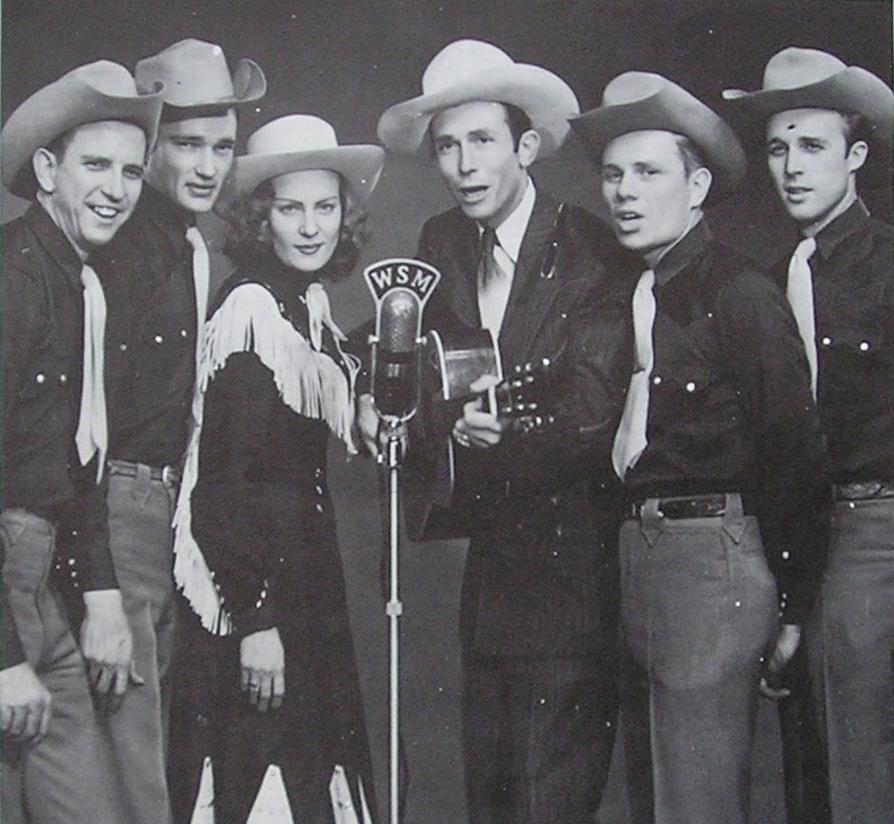 Hank Williams, Audrey Sheppard Williams and the Drifting Cowboys band, in 1951. Public Domain.