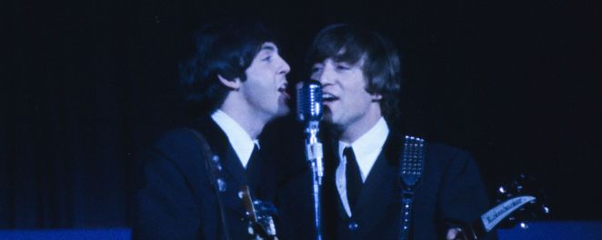 Paul McCartney and John Lennon performing